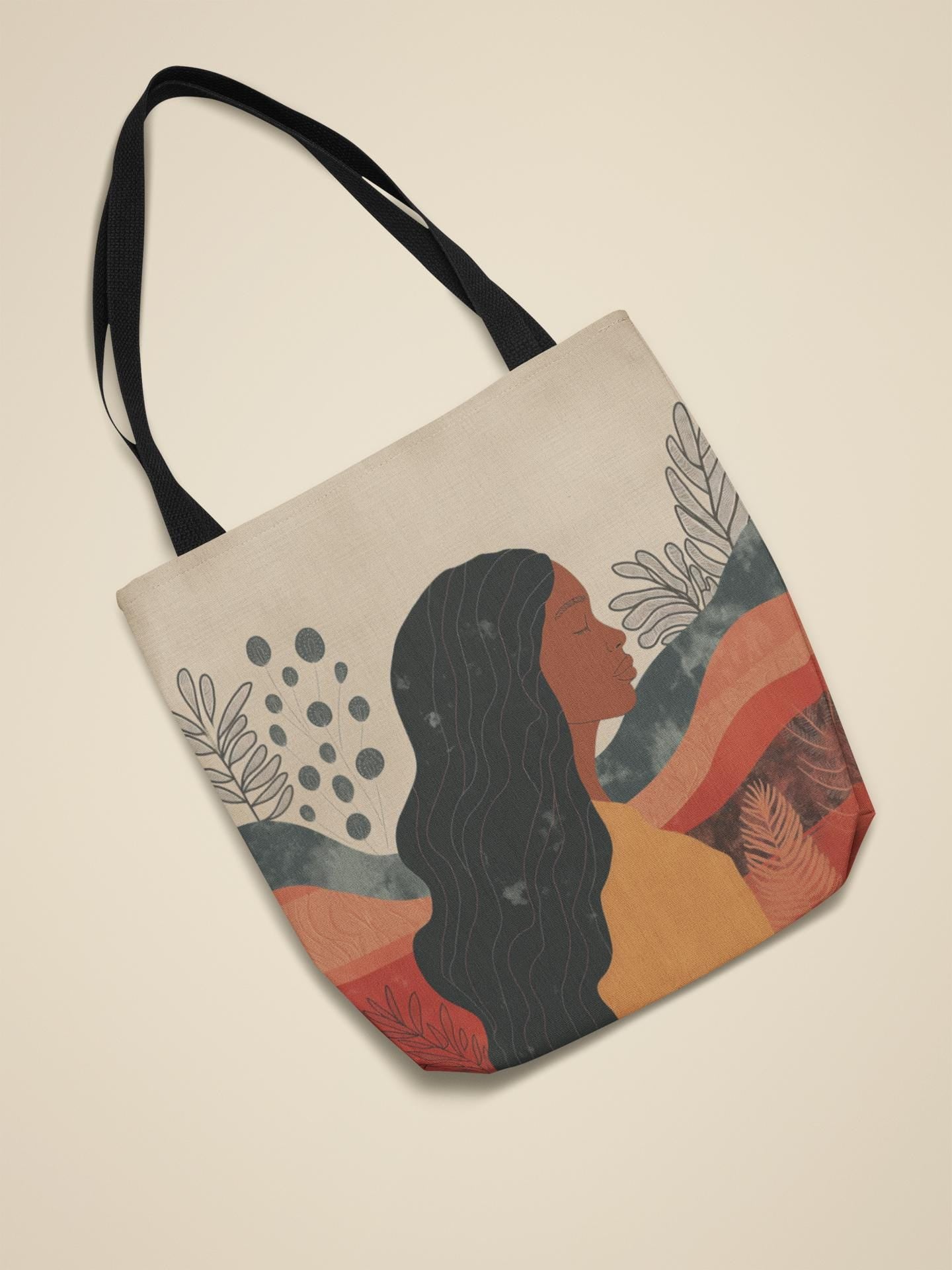 Afrocentric tote bag with abstract silhouette and the words “Peace Be Still,” made from durable polyester with natural cotton handles. Stylish and inspiring for daily use.