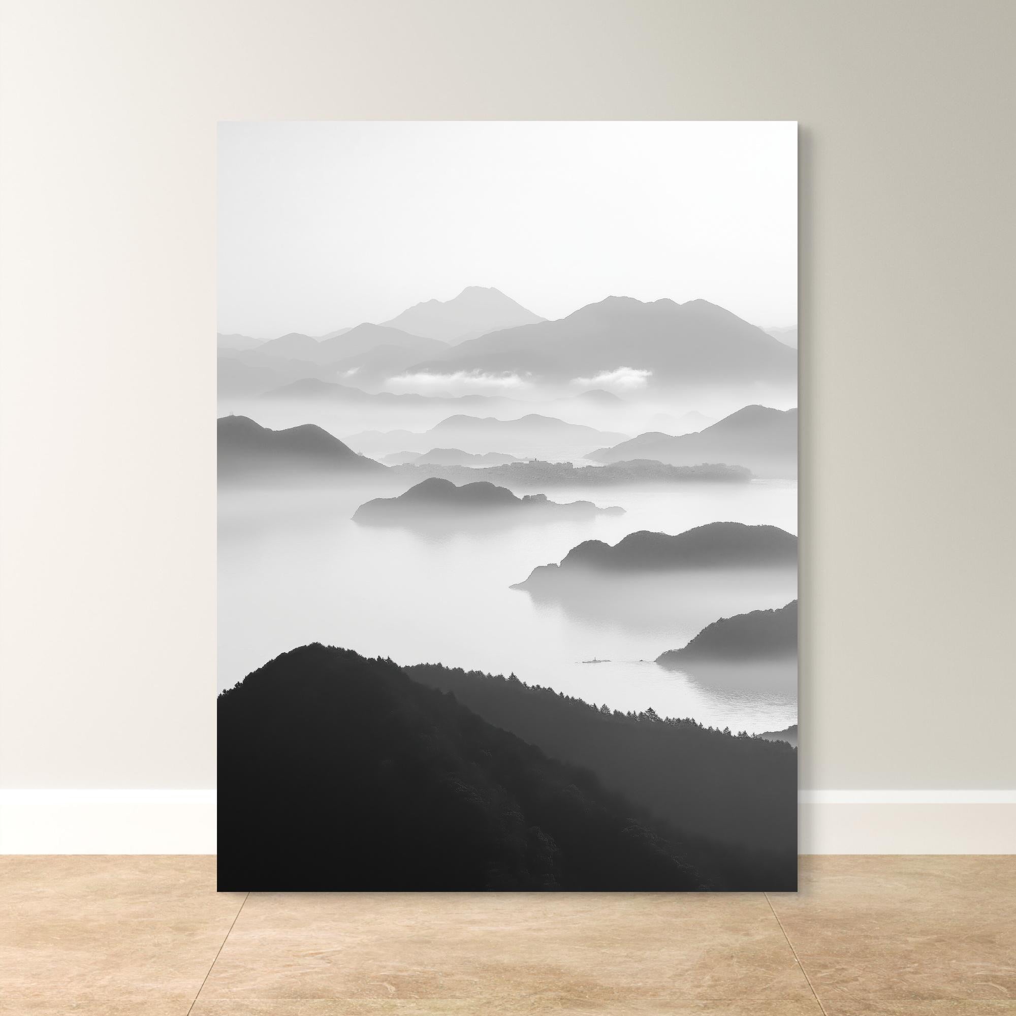 Tranquil Peaks black and white landscape print featuring mist-covered mountains and serene waters, available as a canvas or fine art paper print.